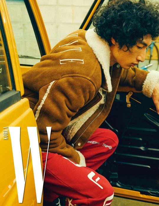 스웨이드 소재의 시어링 재킷과 프린트 티셔츠, 빨간색 스웨트 팬츠는 모두 Off -White 제품.