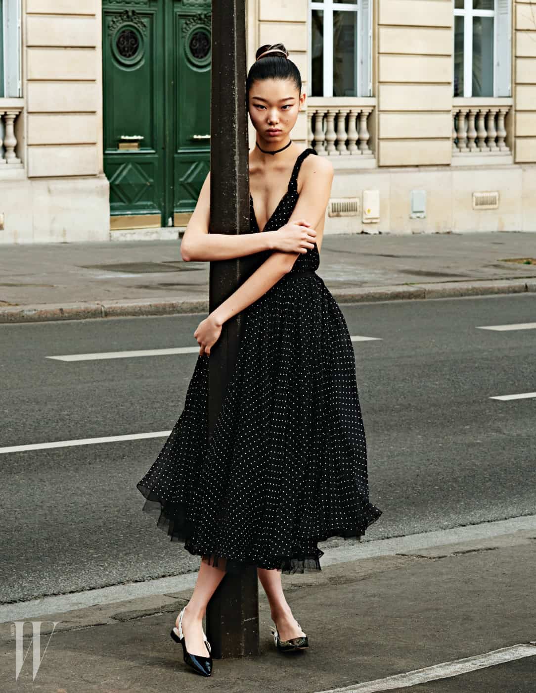 네크라인이 깊게 파인 잔잔한 물방울 무늬 드레스와 플랫 슈즈, 초커는 모두 Dior 제품.