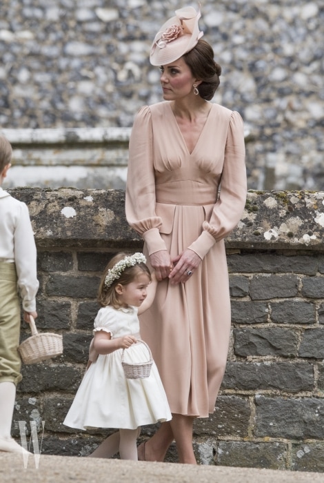 ENGLEFIELD GREEN, ENGLAND - MAY 20: Catherine, Duchess of Cambridge speaks to Princess Charlotte after the wedding of Pippa Middleton and James Matthews at St Mark's Church on May 20, 2017 in in Englefield, England. (Photo by Arthur Edwards - WPA Pool/Getty Images)
