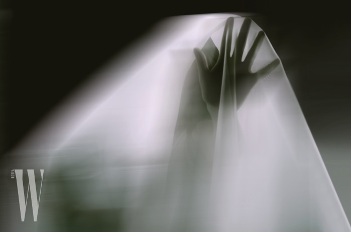 A ghostly apparition of a woman isolated on a black background