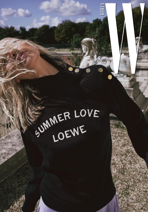어깨 부분 스냅이 포인트인 레터링 스웨터와 줄무늬 패턴 스커트는 Loewe 제품.
