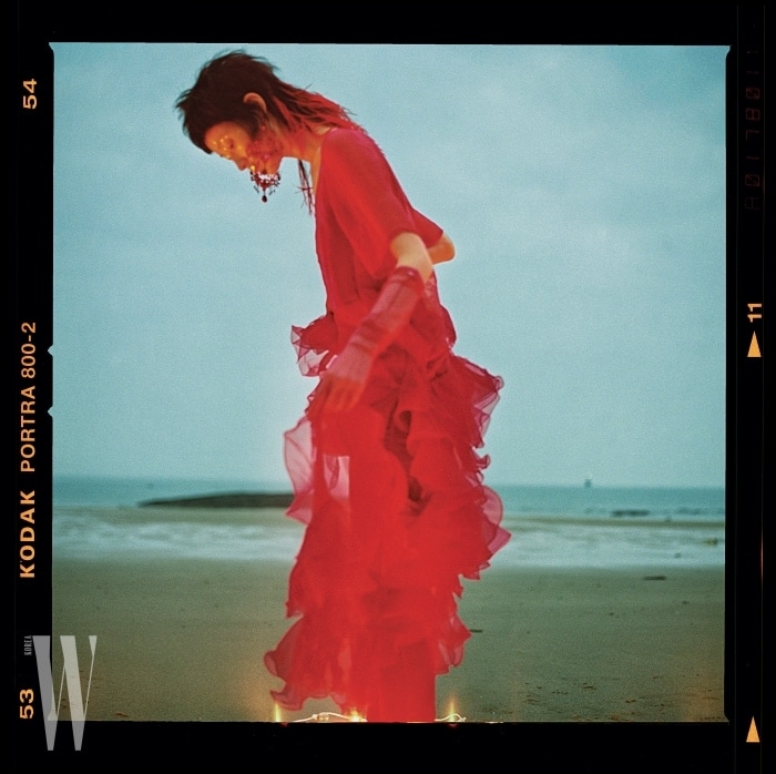 환상적인러플장식의붉은색드레스와샹들리에귀고리, 벨벳 팬츠, 시스루장갑은모두Givenchy 제품.
