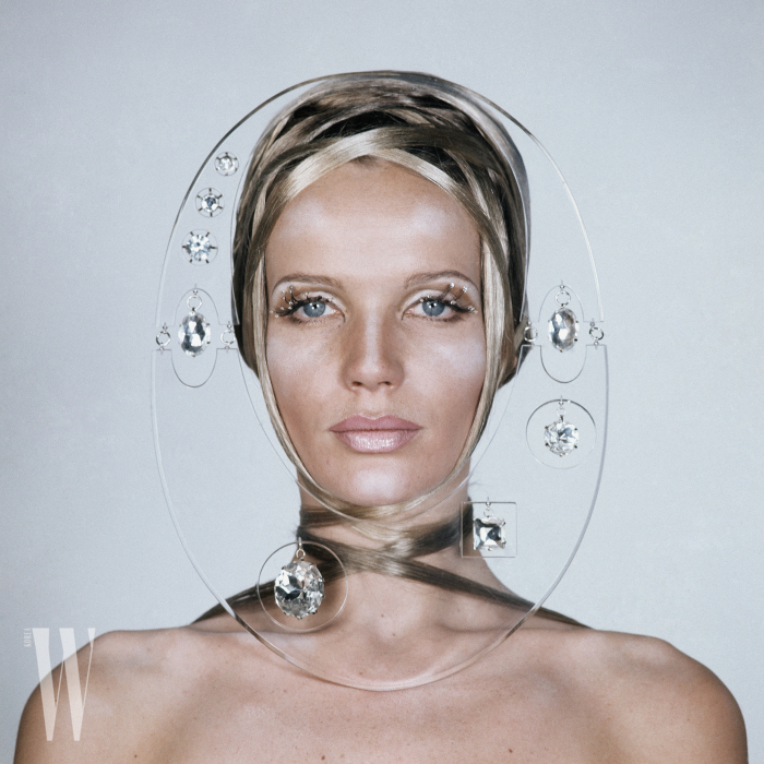 Beauty shot of Veruschka wrapped in strands of her own hair, with shiny stones glued to her eyelashes, and her face framed by clear plexiglass with hanging crystals *** Local Caption *** Veruschka;